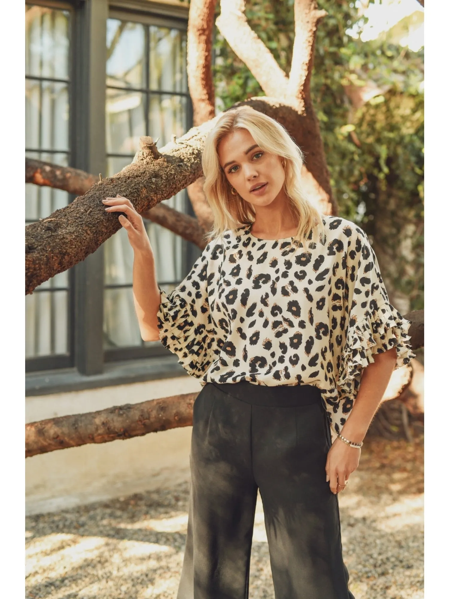 Leopard print top with dolman half sleeves featuring pleated ruffle detail